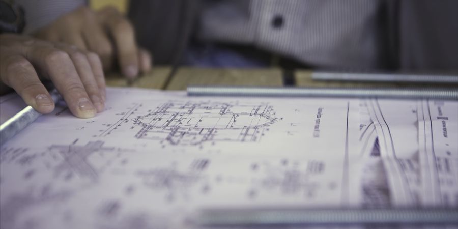 Engineer reviewing technical project documentation for contract administration